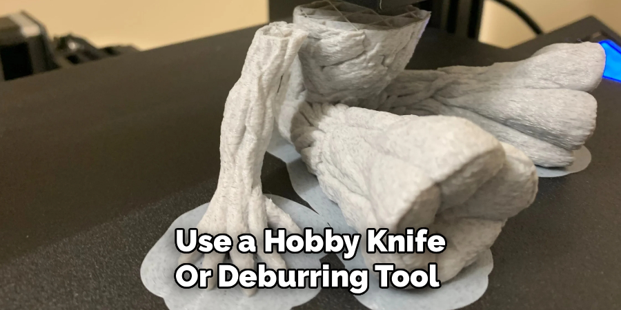 Use a Hobby Knife
Or Deburring Tool 